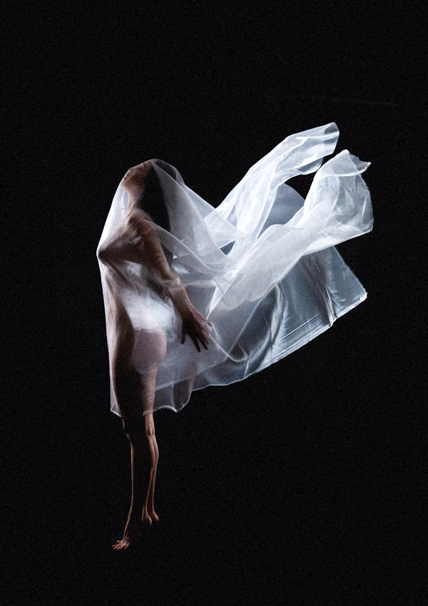 Color artistic photography of a nude model, with a translucent fabric floating over her, motion, black background, by Juan Pablo Galguera